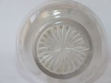 a clear glass bowl with a circular design on it
