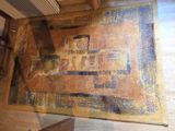 a rug on the floor with a picture of a building on it