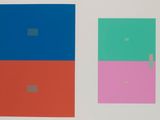 three squares of different colors on a white surface
