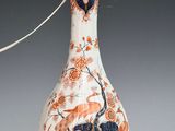 un vase blanc et orange orné d'un motif bleu et rouge