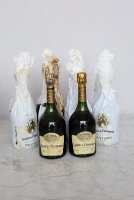 three bottles of champagne sitting next to each other on a table