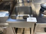 a stainless steel sink in a commercial kitchen