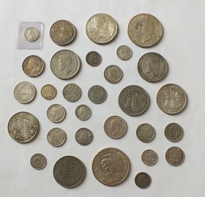a bunch of coins sitting on top of a white surface