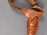a close up of a leather holster on a gray surface
