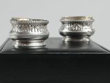 pair of silver plated candlesticks on a black box