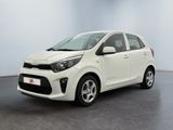 La voiture blanche est garée dans une pièce au sol noir.