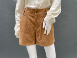 an image of a mannequin mannequin wearing a white shirt and tan shorts