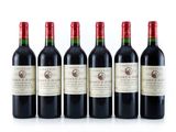 six bottles of red wine lined up on a white surface