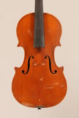 an old violin with a bow hanging from it ' s back