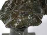 a close up of a bronze bust of a woman on a marble base