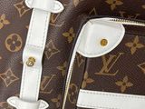 a brown and white louis vuitton bag with a red handle