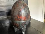 a metal object sitting on top of a black table