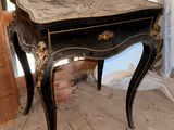 a small table with a drawer on it in a room