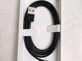 a box with a black and white usb cable in it