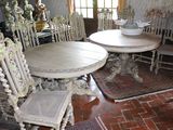 a table and chairs in a room with a rug on the floor