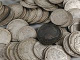 a pile of silver coins sitting on a table
