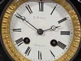 a black and gold clock with roman numerals on it