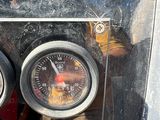 two gauges on the front of a motorcycle