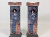 pair of art deco bookends of a woman in a blue dress and hat