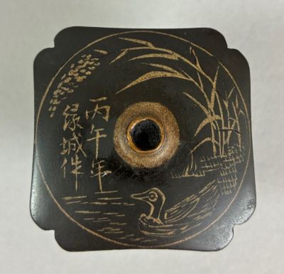 a black and gold plate with writing on it