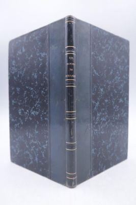 a blue book with a black cover sitting on a white surface