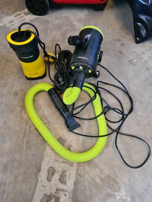 a yellow blow dryer and a black blow dryer sitting on the floor