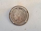 a close up of a silver coin with a woman ' s head on it