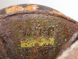 a close up of a rusted metal object with a yellow line on it