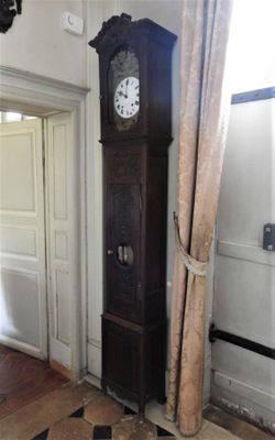 a grandfather clock in the corner of a room