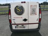 a white van with stickers on it parked in a parking lot
