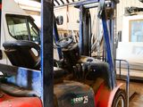 a red forklift truck parked in a warehouse