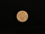 a gold coin on a black background