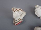 two figurines that are sitting next to each other on a table
