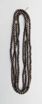 a close up of a strand of beads on a white surface