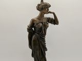 an image of a statue of a woman holding a lamp