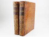 a pair of old books sitting on top of each other