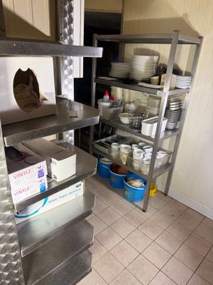 a kitchen with a lot of dishes on the shelves