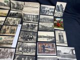 a lot of old black and white photos on the table