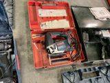 a tool box with a drill and other tools in it