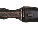 leather sheath for a knife with a black handle on a white background