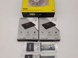 three pieces of hard drives are sitting on a table next to a box of hard drives