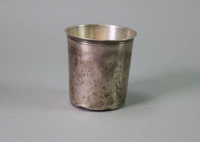 a silver cup that is sitting on a table
