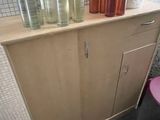 a small cabinet with a lot of bottles on top of it