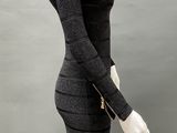 the mannequin is wearing a black dress with a zipper on it