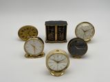 plusieurs types d'horloges posées sur une surface blanche