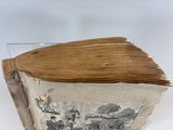 an old book with a picture on it sitting on a table