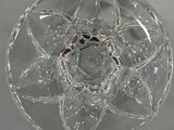 a glass bowl with a ring on it on a table