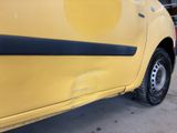 a yellow car that has a black stripe on the side of it