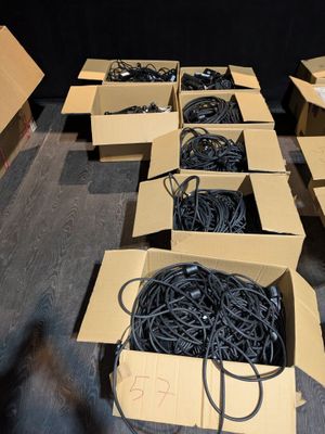 several boxes of wires are lined up in a room