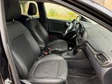 the interior of a car with the door open showing the driver ' s seat area